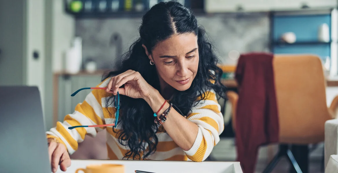 imagem de uma mulher sentada mexendo no computador.